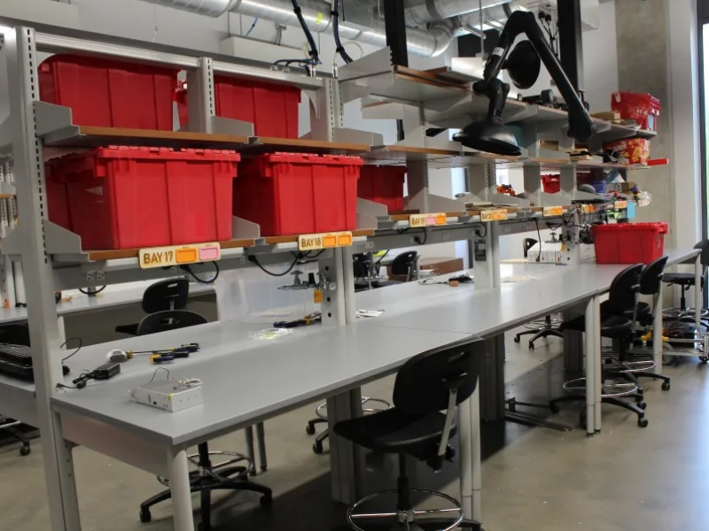 Worktables with buckets and shelving above for storage