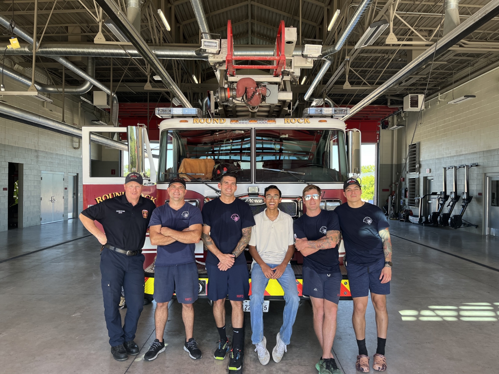 Sidd Thakur with Round Rock fire department sitting on fire truck