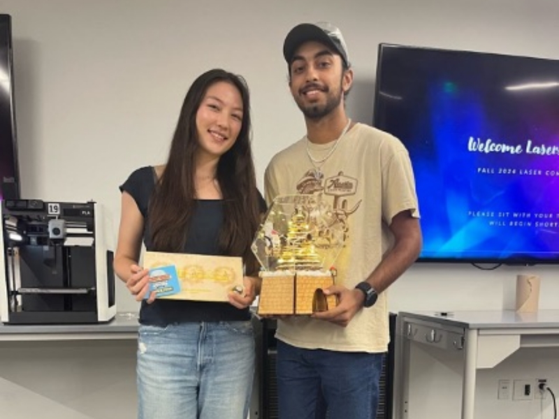 1st place Texas engineering students holding laser project and award for TIW lasers competition