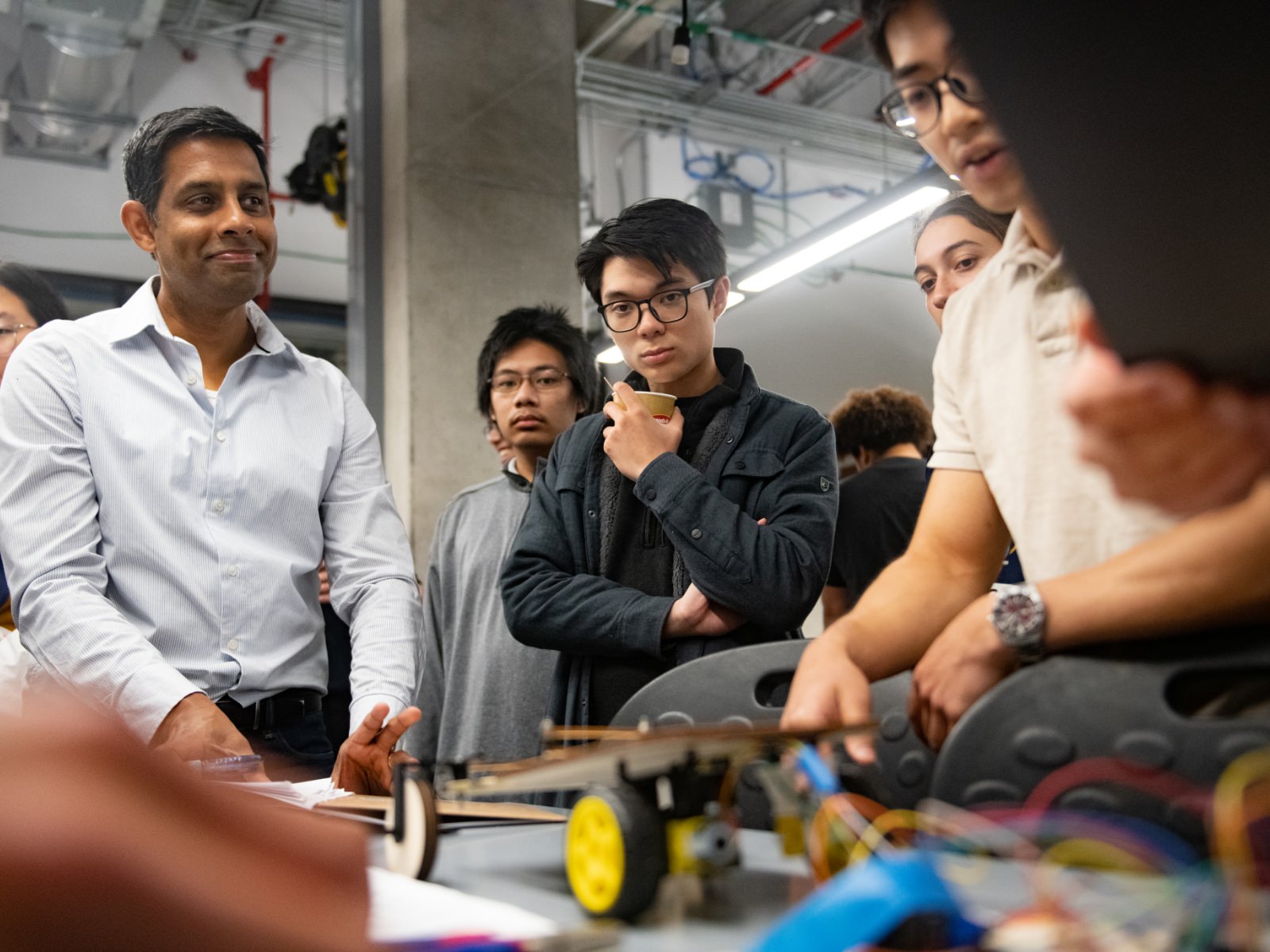 Texas engineering student holding thank you sign with drawing of gears