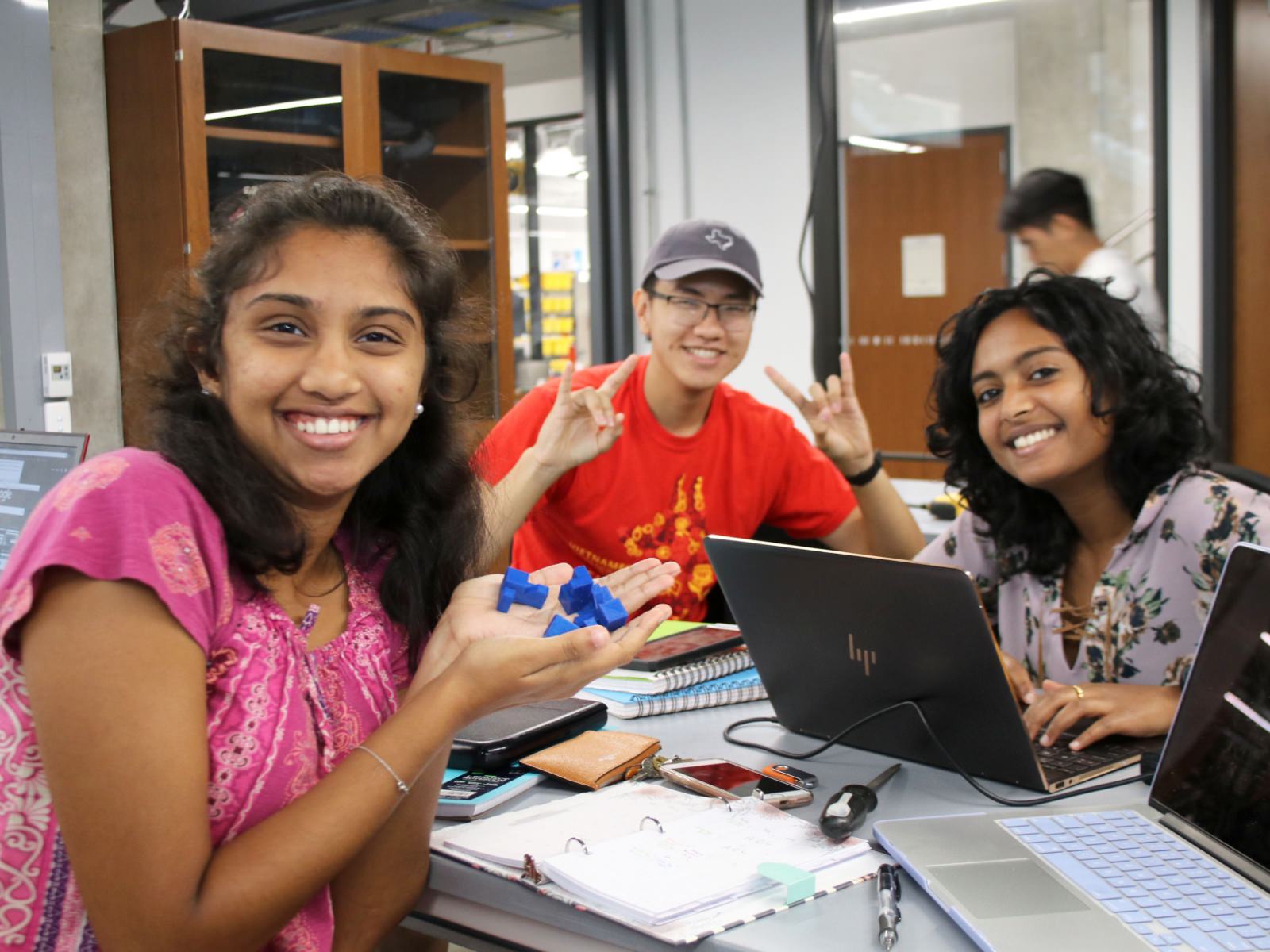 Texas engineering students smiling in TIW makerspace