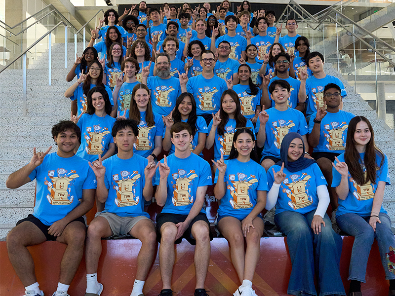 Texas engineering student staff for Texas Inventionworks sitting on steps